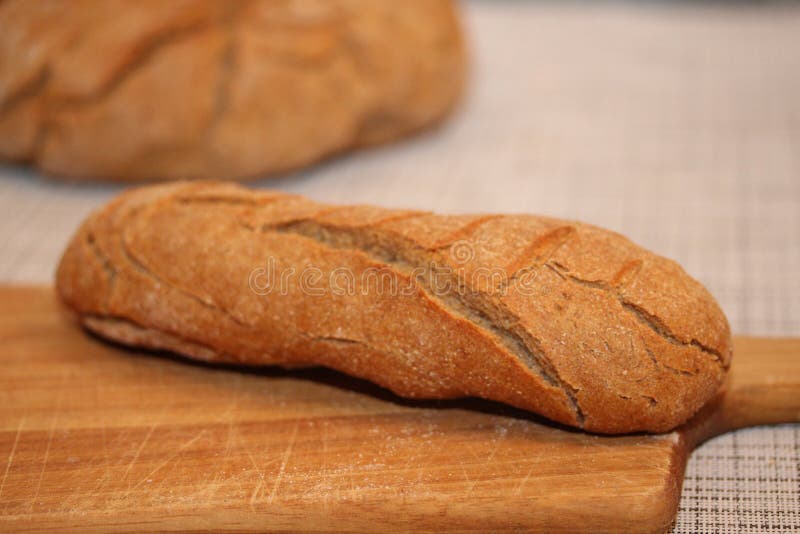 Long French Bread on the Cutting Board. Stock Image Image of