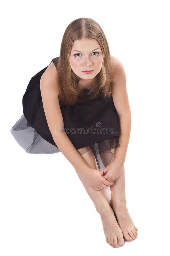 The long-haired girl sitting on the floor