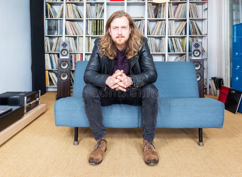 Long haired man intensively listening to music