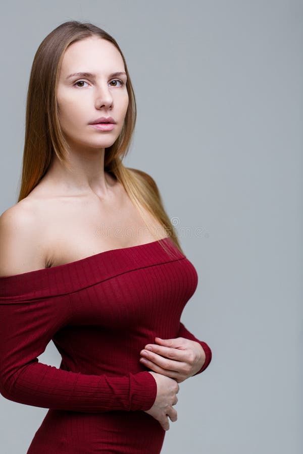 Long-haired woman in red dress stock image