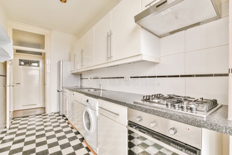 Long Kitchen with Black and White Checkerboard Floor Stock Image