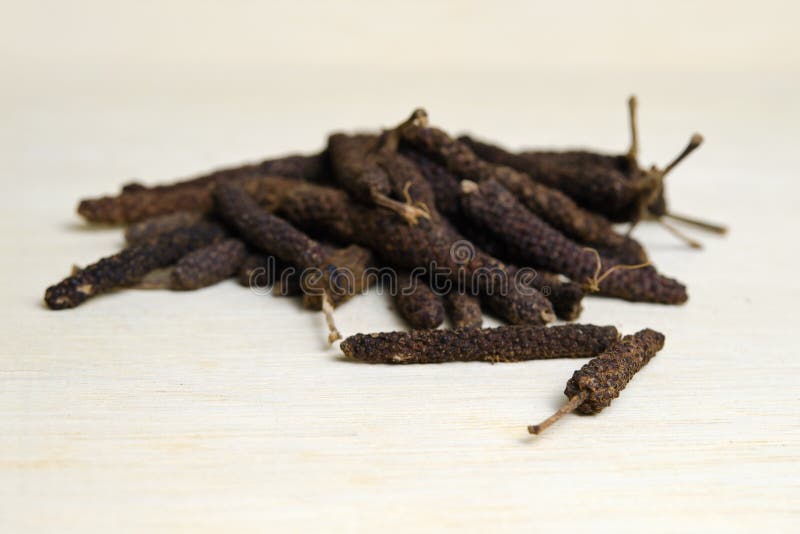 Long pepper or Pipli or Dipli (Piper longum) on wood ba