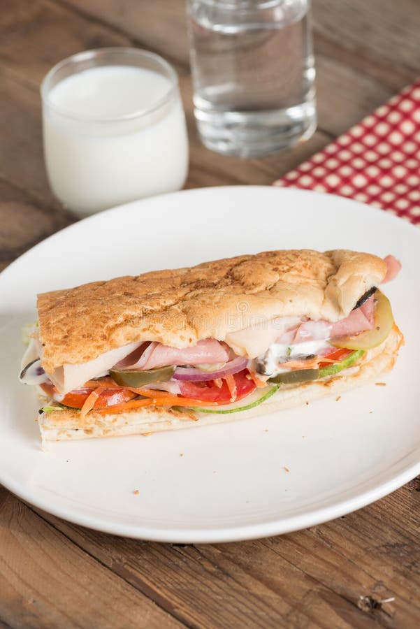 Long Sandwich with Ham, Cheese, Tomatoes, Red Onion and Lettuce. Stock