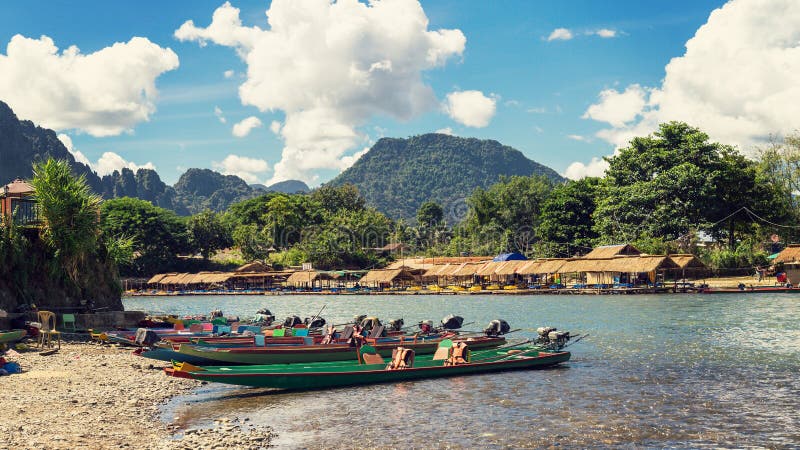 Long tail boats on sunset at Song river, Vang Vieng, Laos.