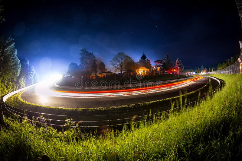 Long time exposure bulb shot of an 24h car race during night motorsport background stock image Long time exposure bulb shot of an 24h car race during night motorsport background stock image