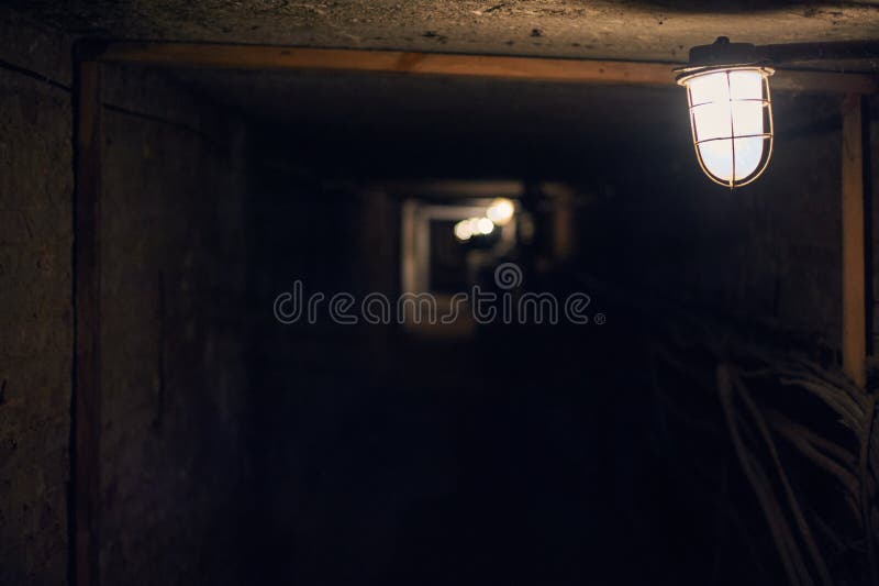 Long Underground Brick Tunnel Angle Shot. Old Lantern in the Foreground