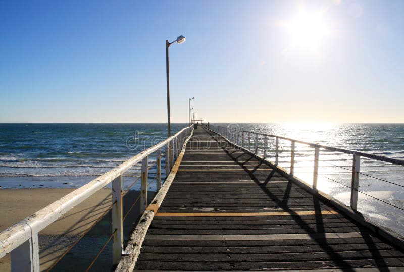 Long Wooden Beach Jetty in Strong Sunlight. royalty free stock images