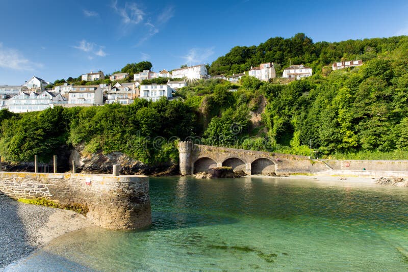 Looe harbour wall Cornwall England with blue green sea