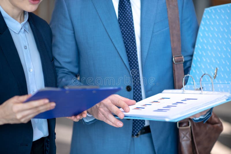 Close up of businessmen looking at documents before singing contract stock images
