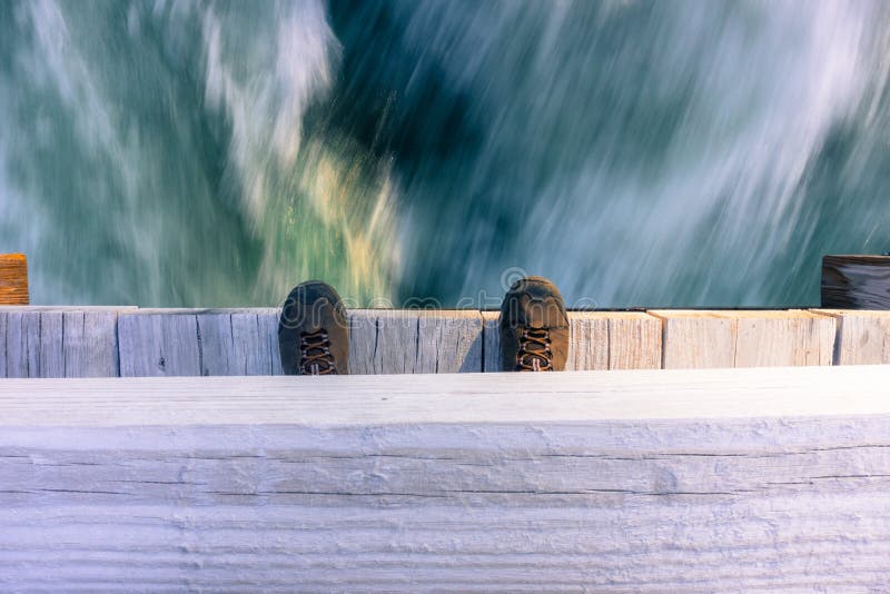 Looking down from a bridge at a fast running river stock images