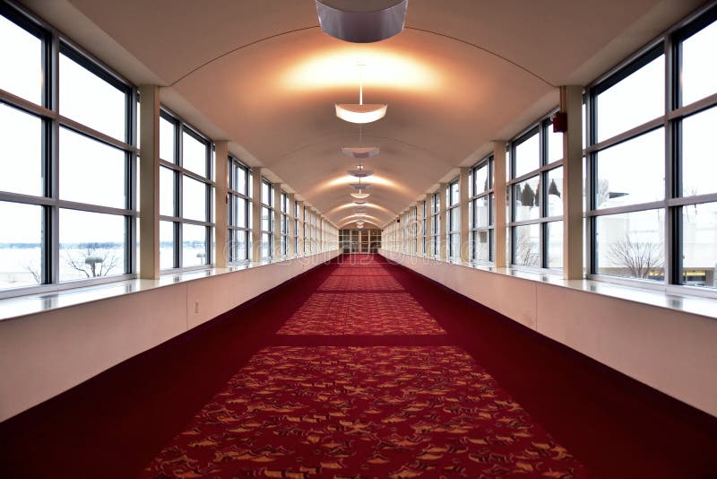 Looking Down a Long Corridor of Red Carpet Windows on Either Side and