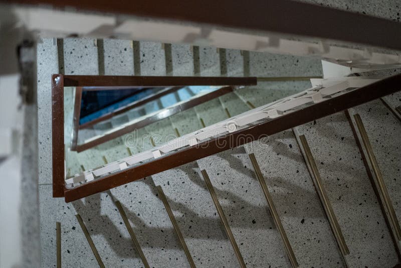Geometric stairwell looking down creating triangle pattern stock photo Geometric stairwell looking down creating triangle pattern stock photo
