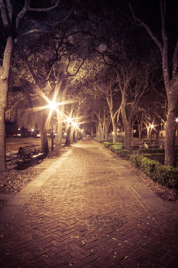 Looking Down the Walkway of a City Park at Night with Lights Stock ...