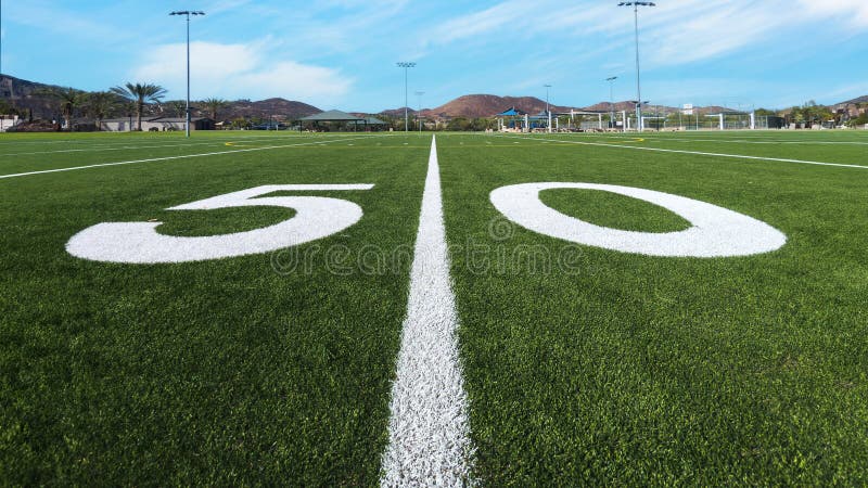 Looking down the 50 yard line on American football field stock images