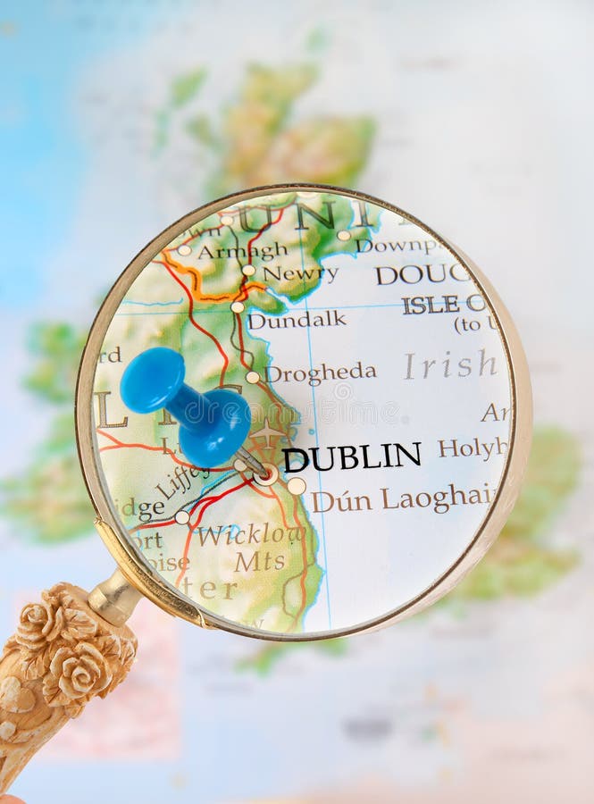 Blue tack on map with magnifying glass looking in on Dublin, Ireland, United Kingdom