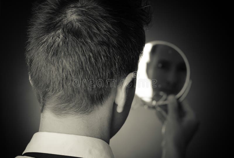 Looking in the mirror and reflecting stock images