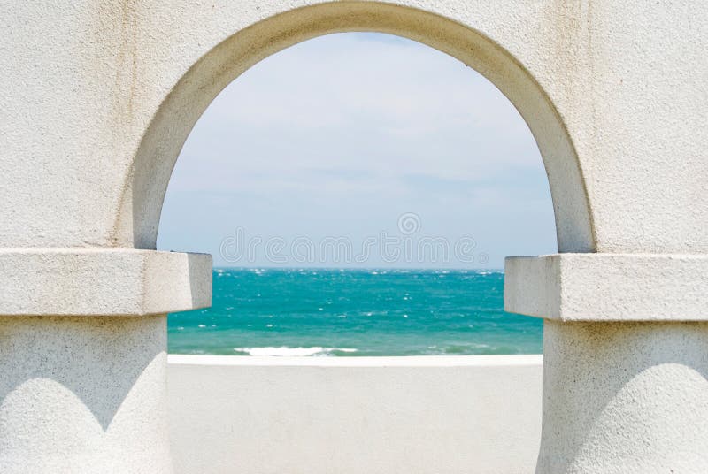 Looking at the ocean through arch door