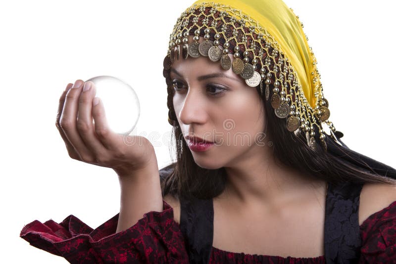 Close up of female fortune teller or psychic with clear crystal ball for composites. Facial expressions indicate she is seeing a vision on in the orb. Close up of female fortune teller or psychic with clear crystal ball for composites. Facial expressions indicate she is seeing a vision on in the orb.