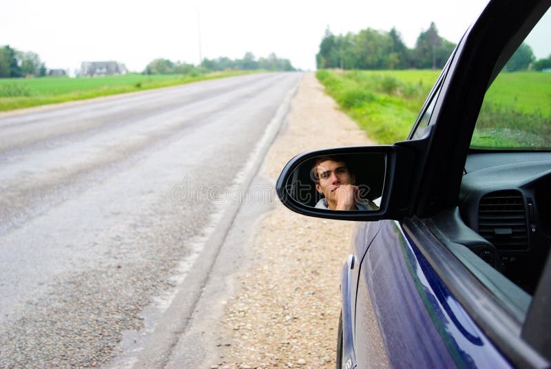 Looking in rear view mirror stock photos