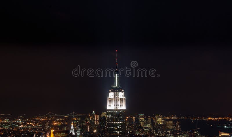 Sundown from the top of the rock - Empire State Building pinnacle brightly lit in the centre of the frame - in colour stock photos Sundown from the top of the rock - Empire State Building pinnacle brightly lit in the centre of the frame - in colour stock photos