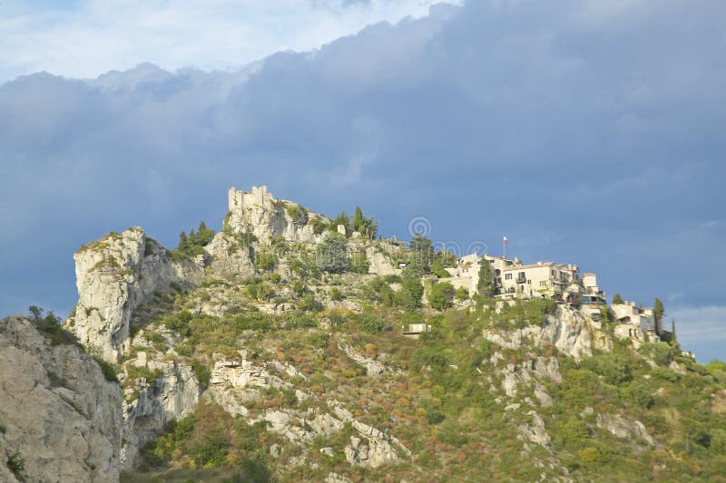 Looking up at Town of La Turbie with Trophee des Alpes and church, France