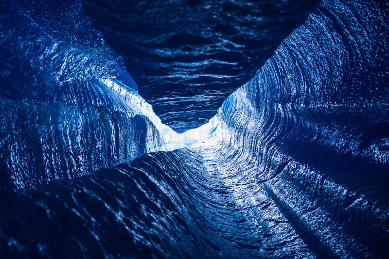 Looking up a vertical passage of a moulin deep inside a glacier