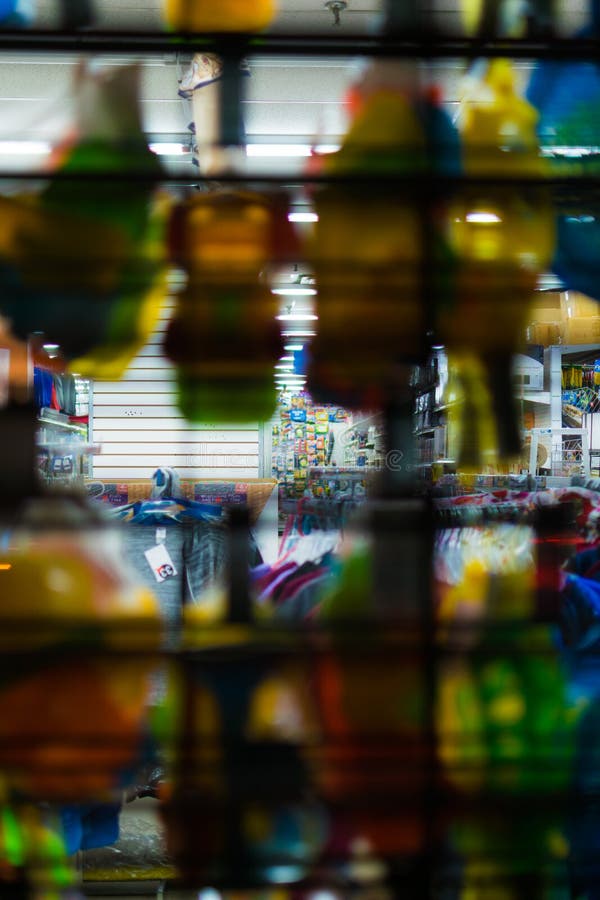 Looking through a window display and closed drop gate, into a retail store at night, Staten Island, New York City, USA royalty free stock images Looking through a window display and closed drop gate, into a retail store at night, Staten Island, New York City, USA royalty free stock images