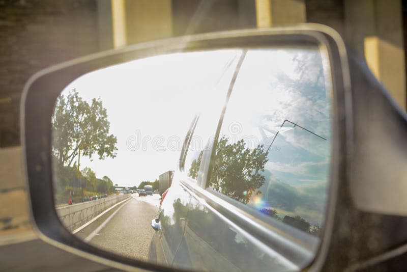 Looking in the Wing Mirror Whilst Driving in a Car Stock Photo Image