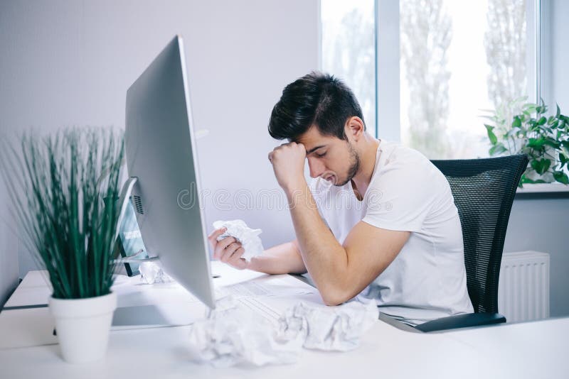 Looking from the working men in the office. Stylish designer at work sitting. Focused on his job royalty free stock photography Looking from the working men in the office. Stylish designer at work sitting. Focused on his job royalty free stock photography