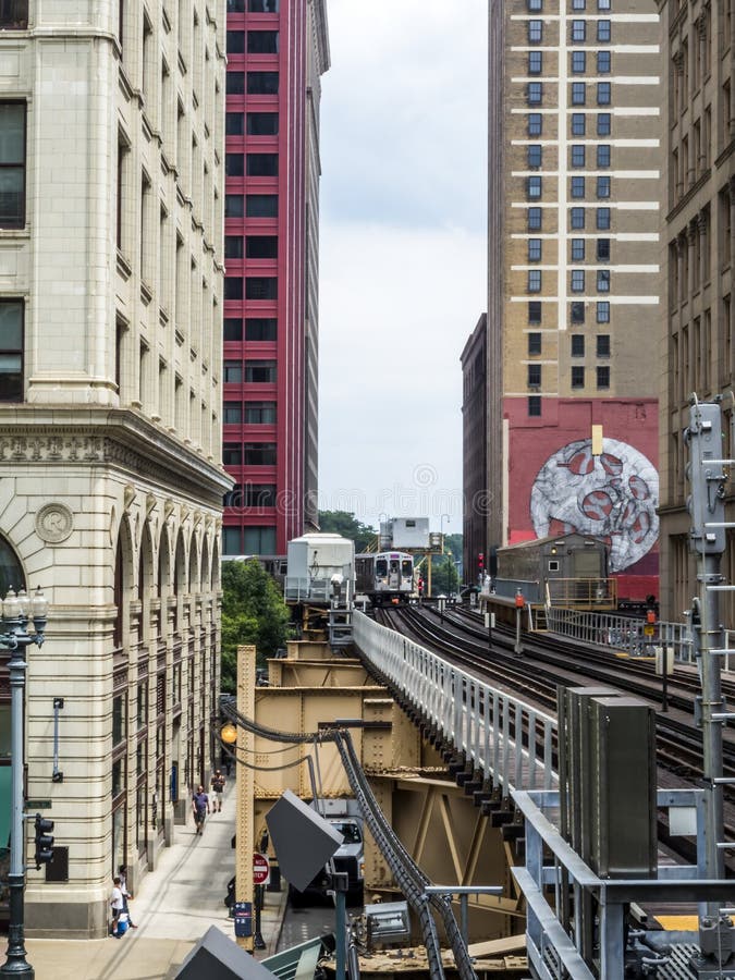 Elevated Train Tracks Above the Streets and between Buildings at the
