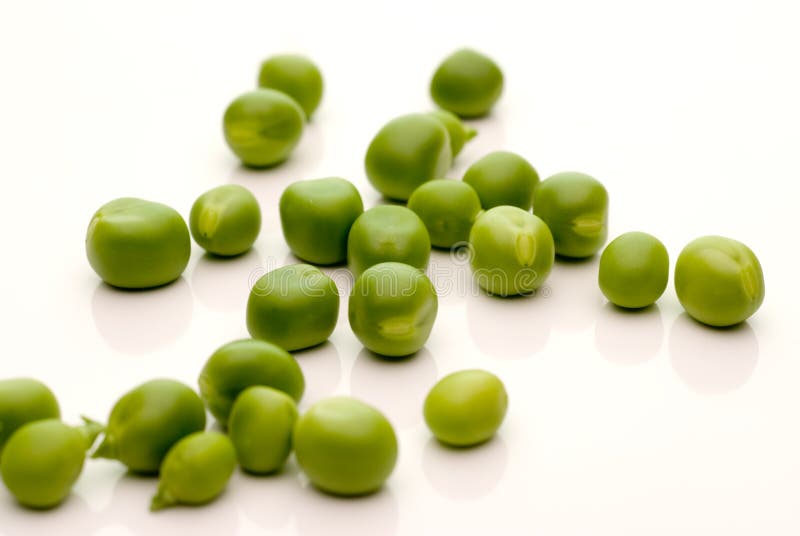 Loose garden peas on white