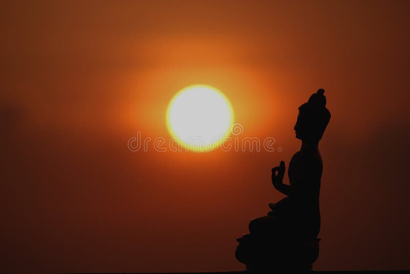 Lord Buddha statue at sunset royalty free stock photography