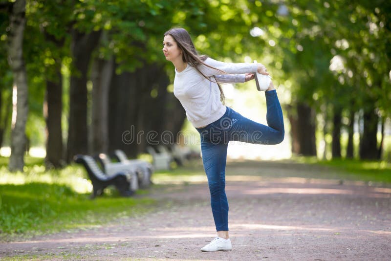 Lord of the Dance pose in park alley