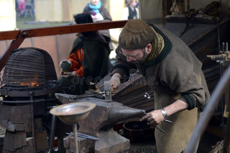 06.04.2015 Lorelay Germany - blacksmith working metal with hammer on the anvil in the forge. 06.04.2015 Lorelay Germany - blacksmith working metal with hammer on the anvil in the forge