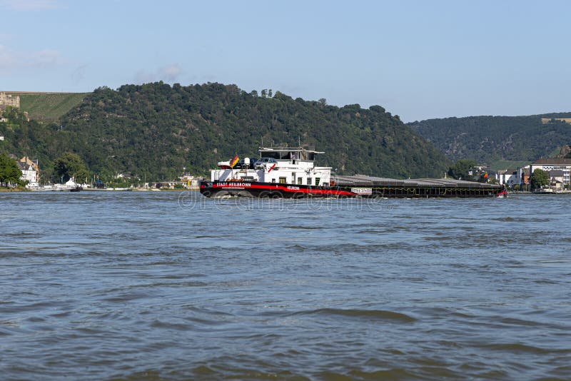 Loreley, Germany - 25 July 2021. A large barge on the river Rhine in Germany for the transport of coal or aggregate. Large warehou royalty free stock photos