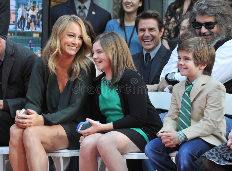 LOS ANGELES, CA - DECEMBER 3, 2013: Ben Stiller\'s wife Christine Taylor & children Ella, 11, & Quinlin, 8, with Tom Cruise in background at the TCL Chinese Theatre where Stiller had his hand & footprints set in cement. LOS ANGELES, CA - DECEMBER 3, 2013: Ben Stiller\'s wife Christine Taylor & children Ella, 11, & Quinlin, 8, with Tom Cruise in background at the TCL Chinese Theatre where Stiller had his hand & footprints set in cement