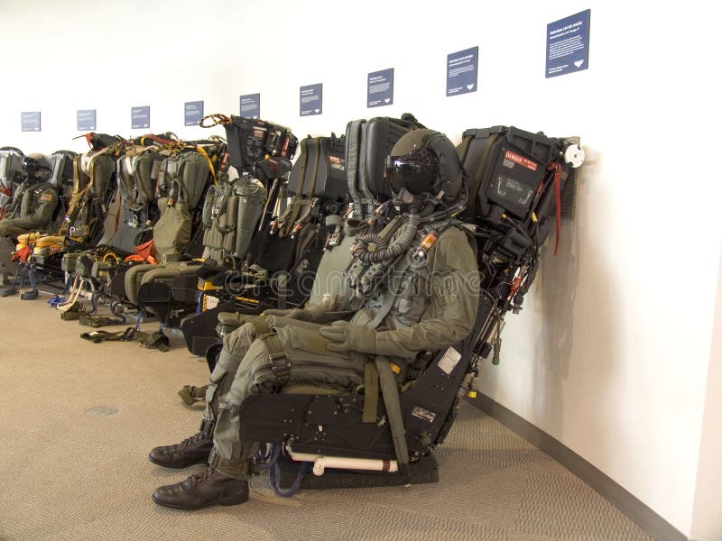 A row of fighter plane ejection seats with a dummy. A row of fighter plane ejection seats with a dummy