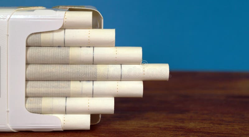 Cigarettes pack on desktop. Tobacco cigarettes pack on the desk of table. Cigarettes pack on desktop. Tobacco cigarettes pack on the desk of table.