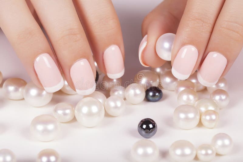 Beautiful woman's nails with french manicure and pearls. Beautiful woman's nails with french manicure and pearls.