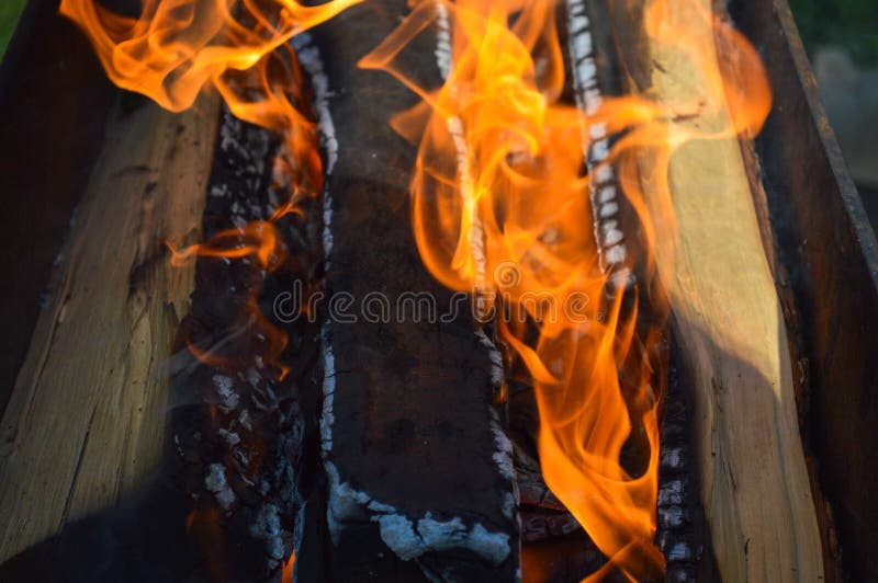 Los tablones carbonizados calientes ardientes de madera de la madera abren una sesión un fuego con las lenguas del fuego y del hu imagen de archivo Los tablones carbonizados calientes ardientes de madera de la madera abren una sesión un fuego con las lenguas del fuego y del hu imagen de archivo