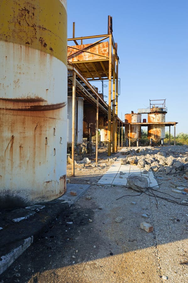 View of old, rusty storage tanks in an abandoned industrial unit in Greece. View of old, rusty storage tanks in an abandoned industrial unit in Greece.