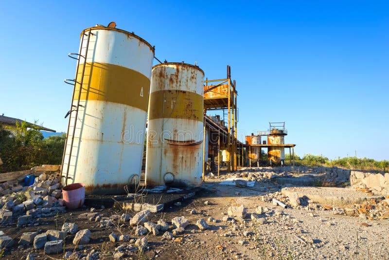 View of old, rusty storage tanks in an abandoned industrial unit in Greece. View of old, rusty storage tanks in an abandoned industrial unit in Greece.