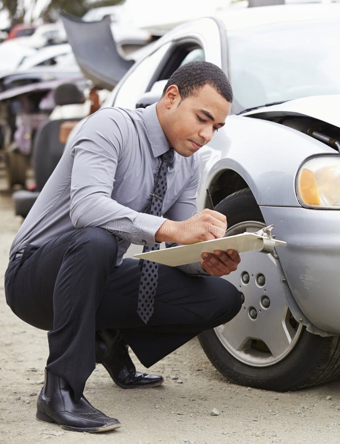 Loss Adjuster Inspecting Car Involved in Accident Stock Photo Image