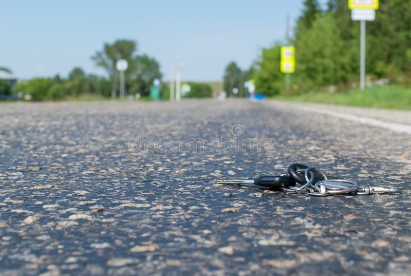 Lost a bunch of keys lying on the asphalt surface stock photo
