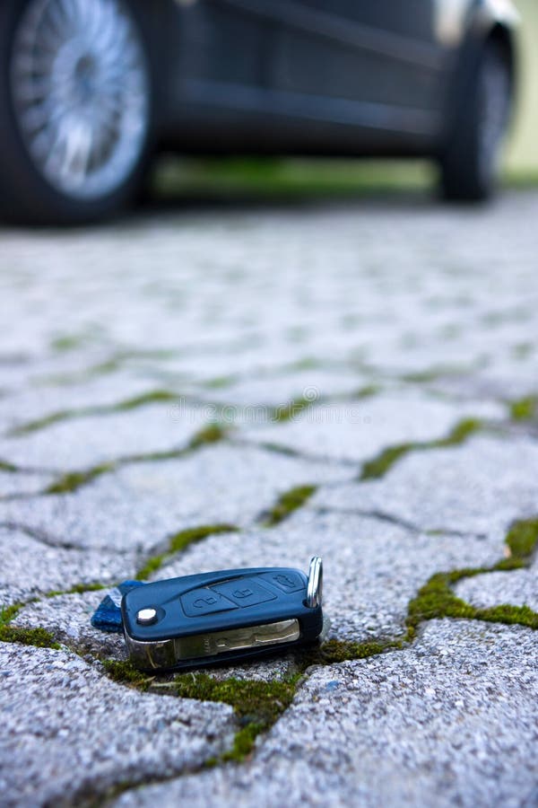 Car Key Fall on the Asphalt Road. Driver Lost His Vehicle Keys and Walks  Away. Misfortune Concept Stock Photo - Image of cement, door: 215464114