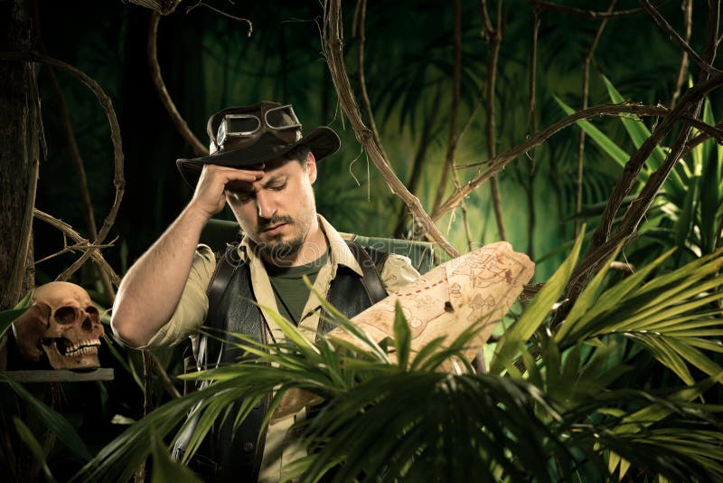 Young explorer lost in jungle examining an old map. Adventurer adventure stock images, royalty-free photos and pictures