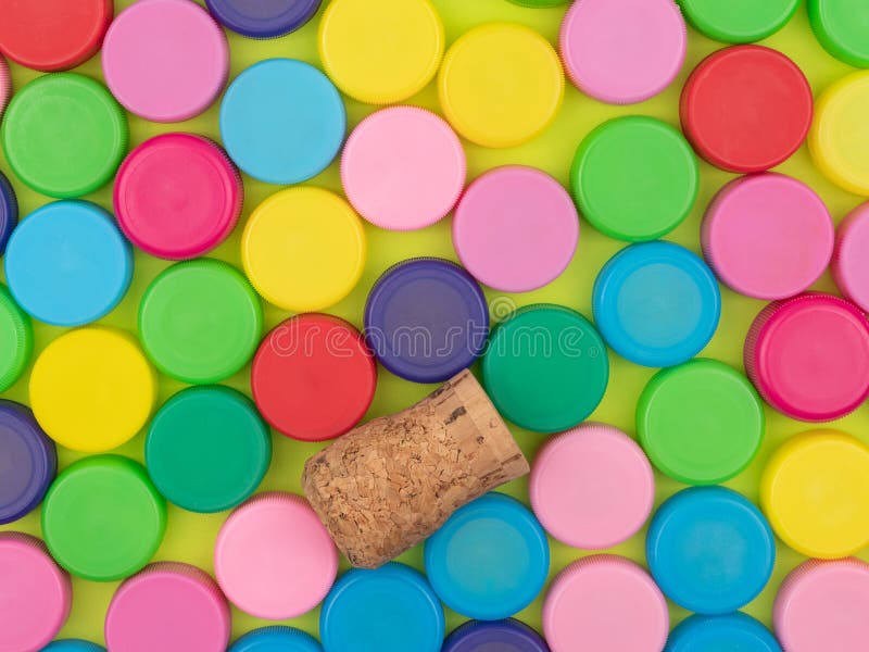 Lot of colorful plastic lids and a wooden tube stock photo