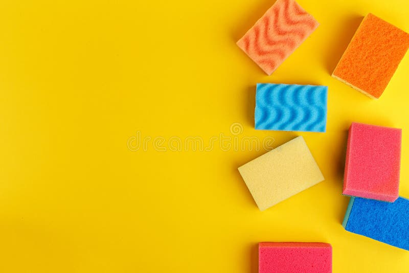 Set multi-colored sponges on a yellow background, space for text. Multi colored foam sponges stock images, royalty-free photos and pictures