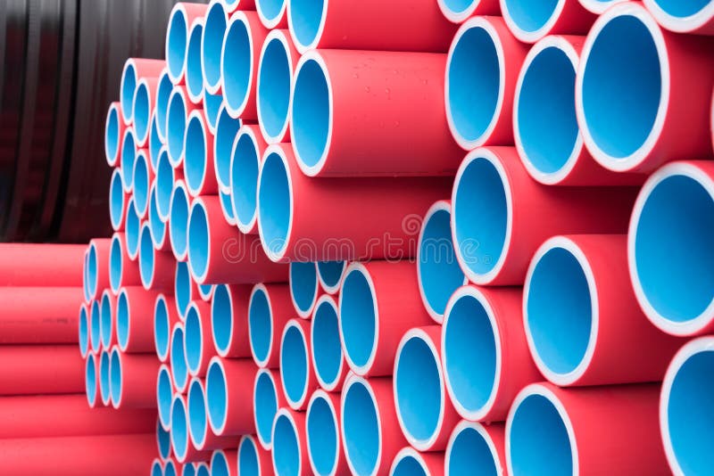 Blue Plastic Pipes Stacked in Rows. Look Inside the Pipe. Background