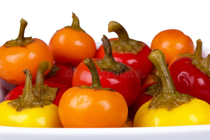 A lot of round hot peppers of different colors